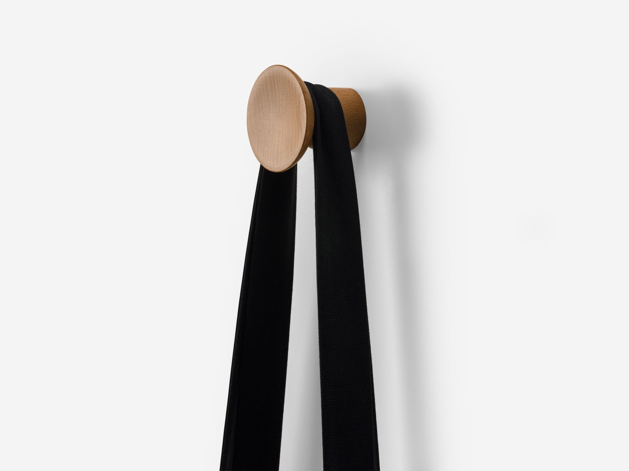 Angle view of medium beech wall hook with bag on it